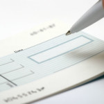 blank-cheque-being-signed-610